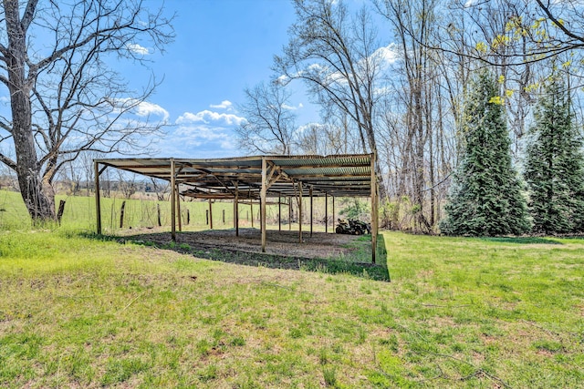 view of yard featuring a rural view and a detached carport