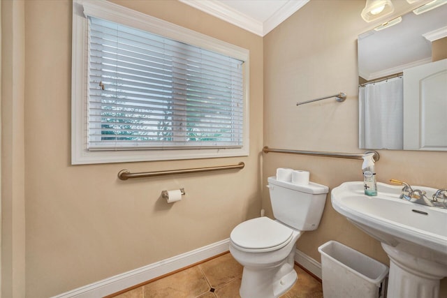 bathroom with ornamental molding, tile flooring, toilet, and sink