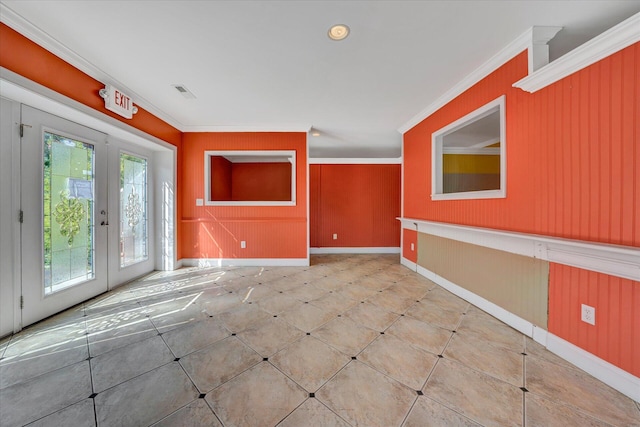 tiled spare room with ornamental molding, french doors, and a wealth of natural light