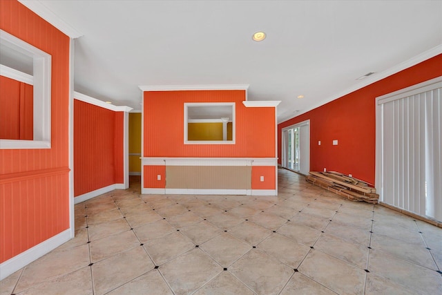 spare room with ornamental molding and light tile floors