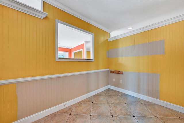 tiled empty room featuring crown molding