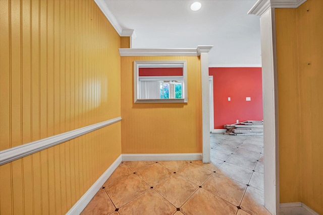 hallway with light tile flooring and ornamental molding