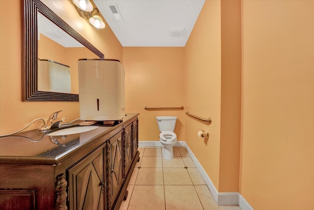 bathroom featuring toilet, tile floors, and vanity