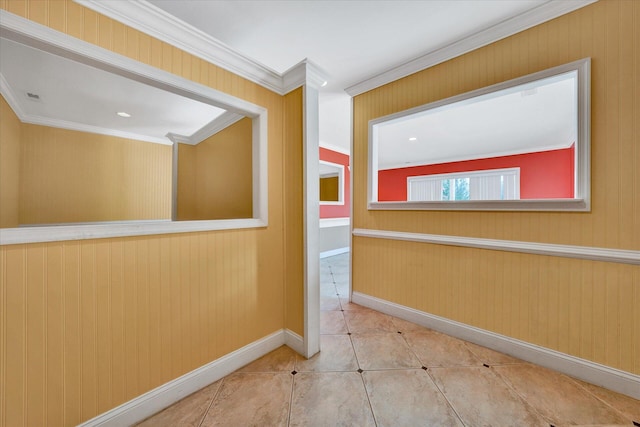 tiled spare room featuring crown molding