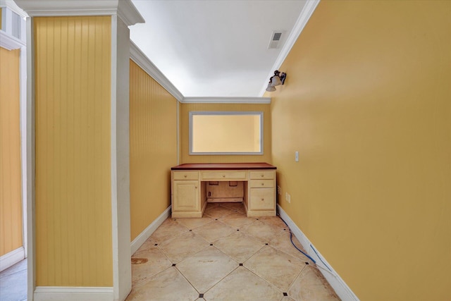 hall featuring light tile floors and crown molding