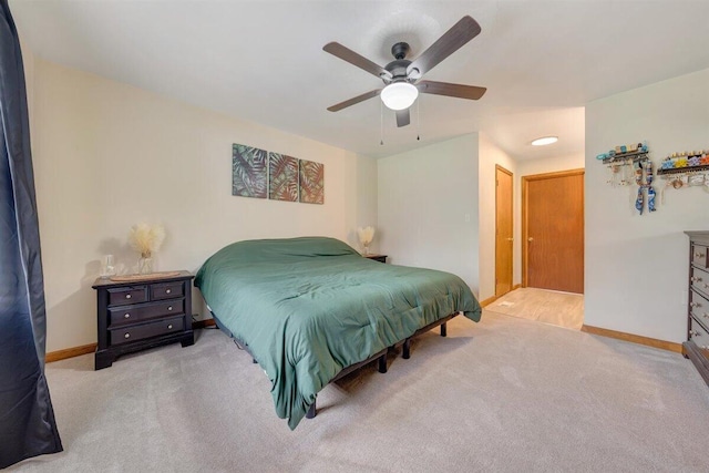 carpeted bedroom featuring ceiling fan and a closet