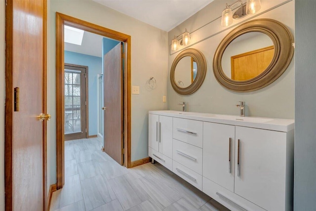 bathroom with vanity and a skylight