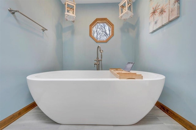 bathroom featuring wood-type flooring and a tub