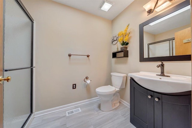 bathroom featuring vanity, toilet, and walk in shower