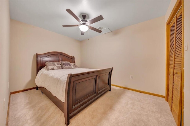 bedroom featuring ceiling fan, a closet, and light colored carpet