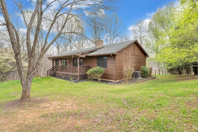 view of front of home with a front yard and cooling unit