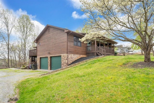 view of home's exterior with a garage and a yard