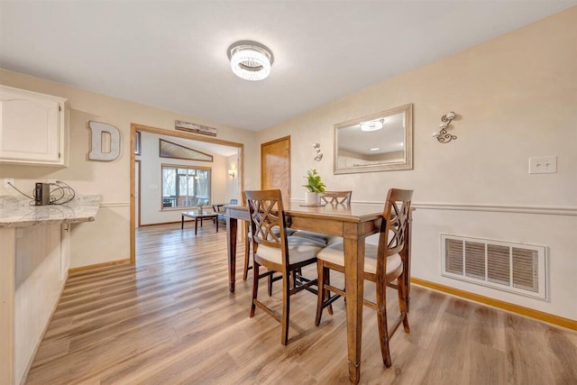 dining space featuring light hardwood / wood-style floors