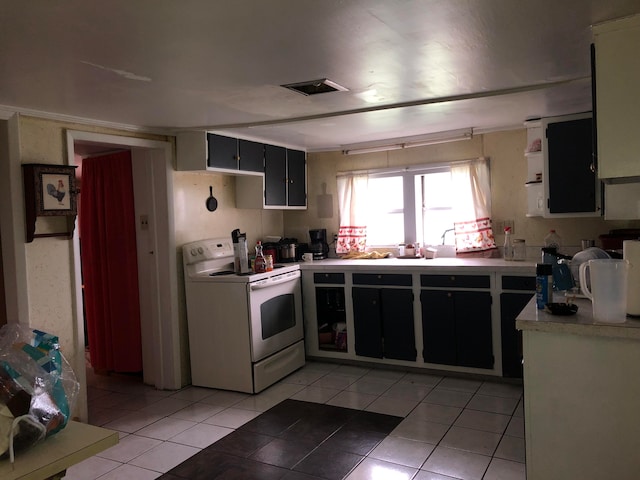 kitchen featuring white range with electric cooktop and light tile flooring