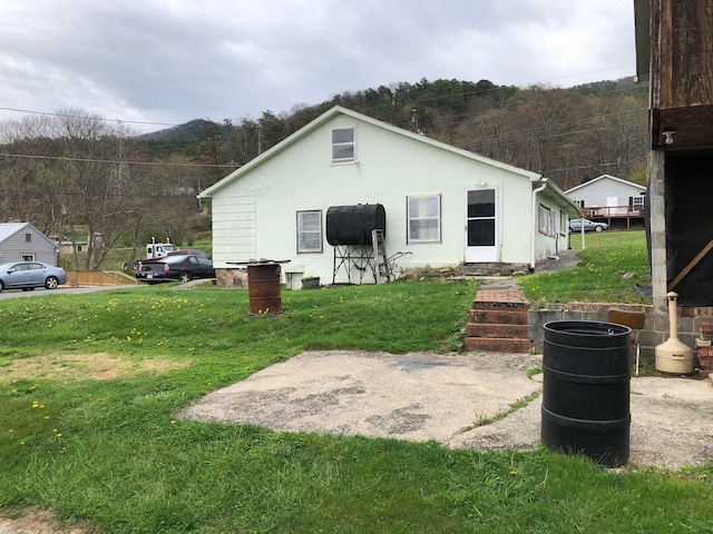 rear view of property featuring a yard