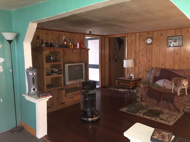 living room featuring wooden walls and dark hardwood / wood-style flooring