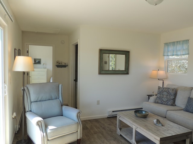 living room featuring a baseboard heating unit and dark hardwood / wood-style floors