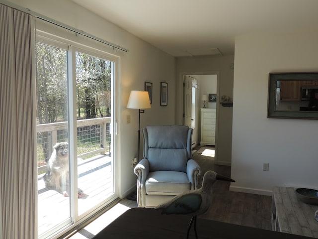 sitting room with plenty of natural light and hardwood / wood-style floors