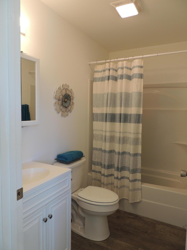 full bathroom featuring shower / bath combo with shower curtain, toilet, hardwood / wood-style flooring, and vanity