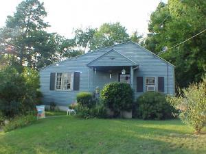 bungalow-style house with a front lawn