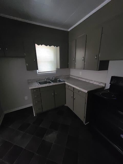 kitchen featuring light countertops, electric range, ornamental molding, a sink, and baseboards