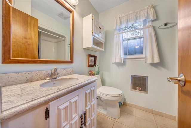 bathroom featuring tile patterned flooring, vanity, toilet, and heating unit