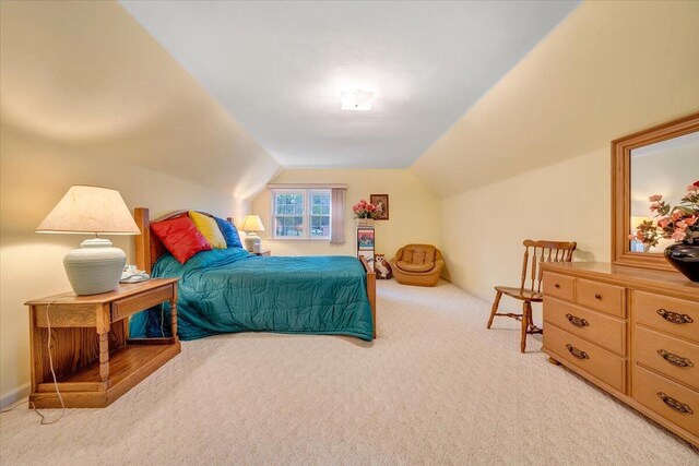 carpeted bedroom featuring vaulted ceiling