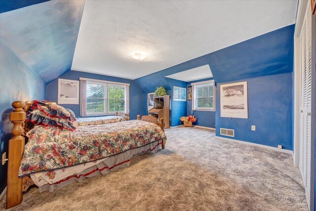 bedroom featuring carpet flooring and vaulted ceiling