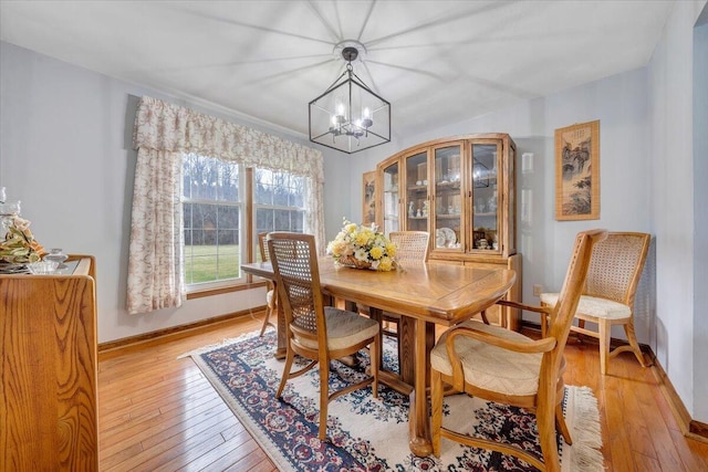 dining area featuring an inviting chandelier and light wood-type flooring