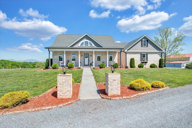 view of front of property with a porch and a front lawn