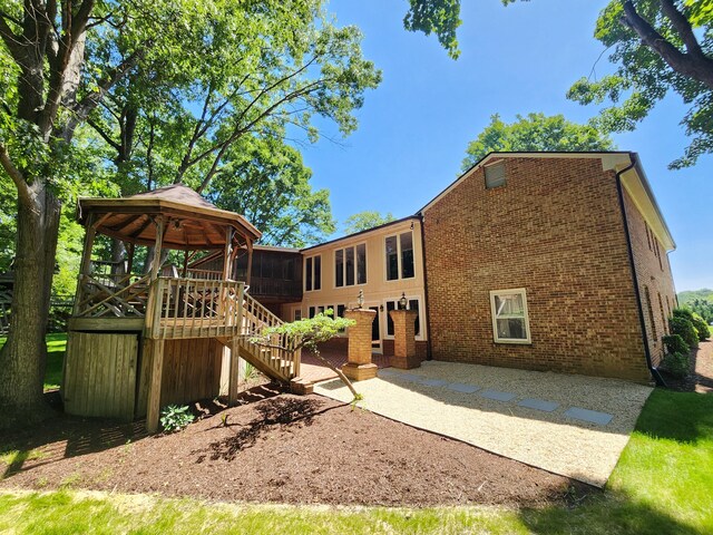 back of house featuring a yard and a deck