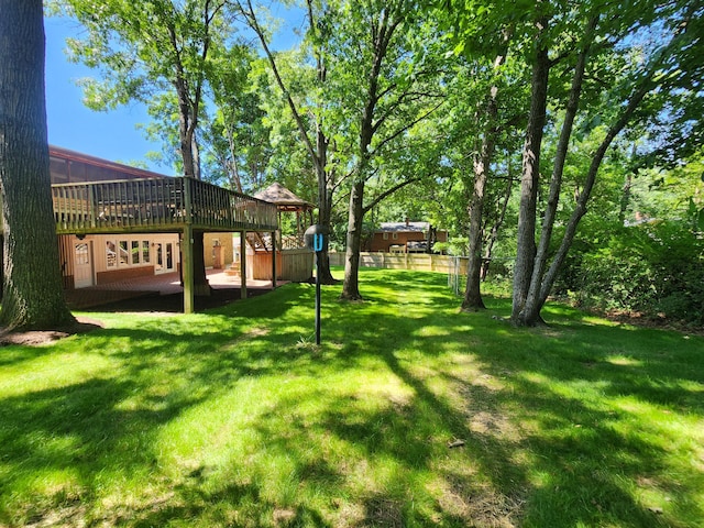 view of yard featuring a wooden deck and a patio area