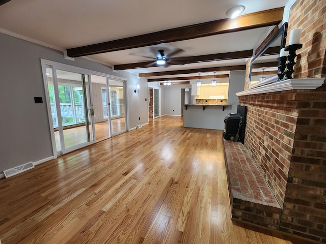 unfurnished living room featuring ceiling fan, beam ceiling, and light hardwood / wood-style flooring