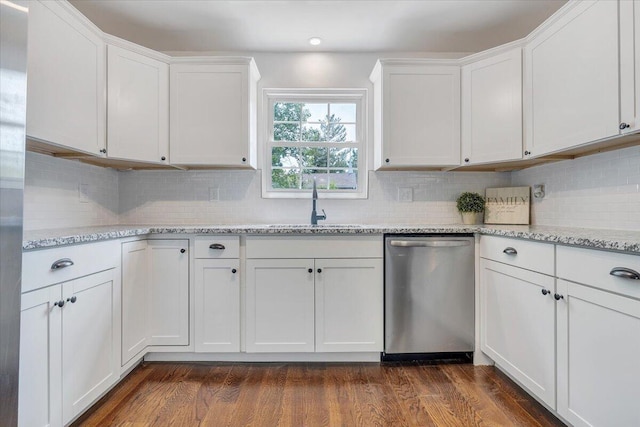 kitchen featuring dark hardwood / wood-style flooring, white cabinets, tasteful backsplash, and stainless steel dishwasher