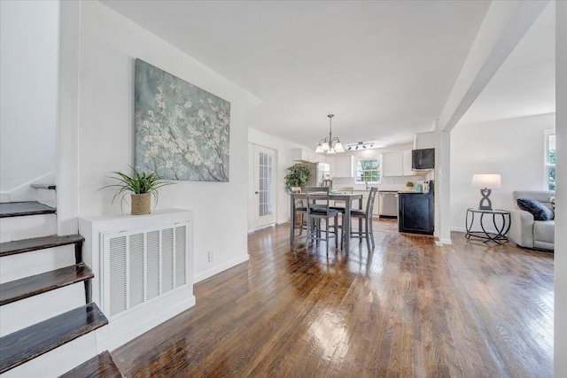 dining room with a chandelier and wood-type flooring