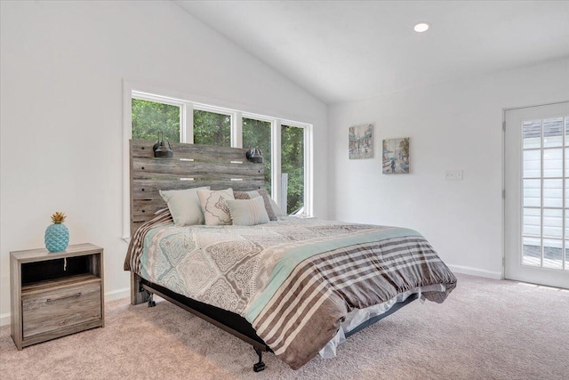 bedroom with multiple windows, carpet flooring, and lofted ceiling