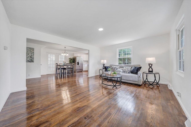 living room featuring dark hardwood / wood-style floors and a chandelier