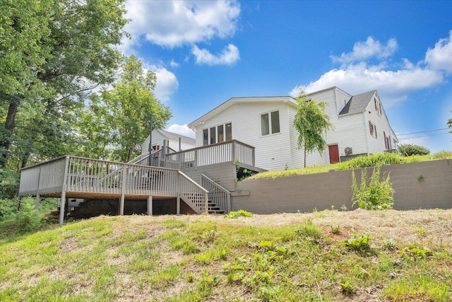 rear view of house featuring a wooden deck