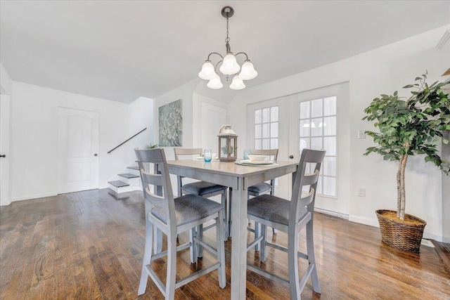 dining area with an inviting chandelier and wood-type flooring