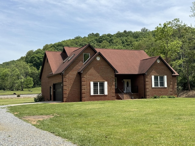 view of front of house with a garage and a front yard