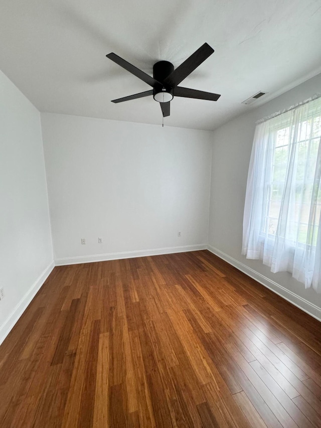 empty room featuring ceiling fan and hardwood / wood-style floors