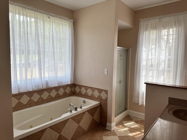 bathroom with a wealth of natural light, tile flooring, and shower with separate bathtub