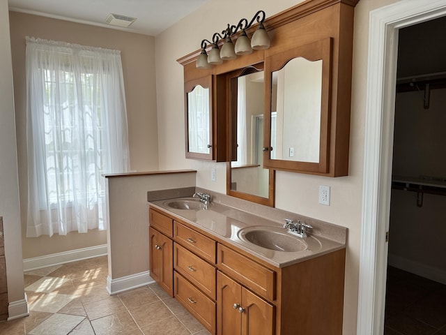 bathroom featuring tile floors and dual bowl vanity