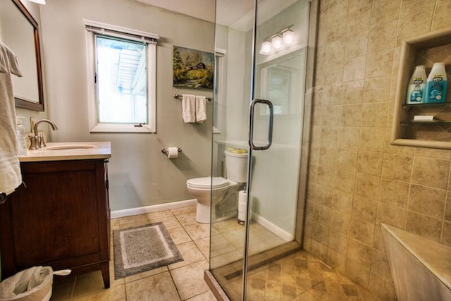 bathroom featuring a shower with door, tile flooring, vanity, and toilet