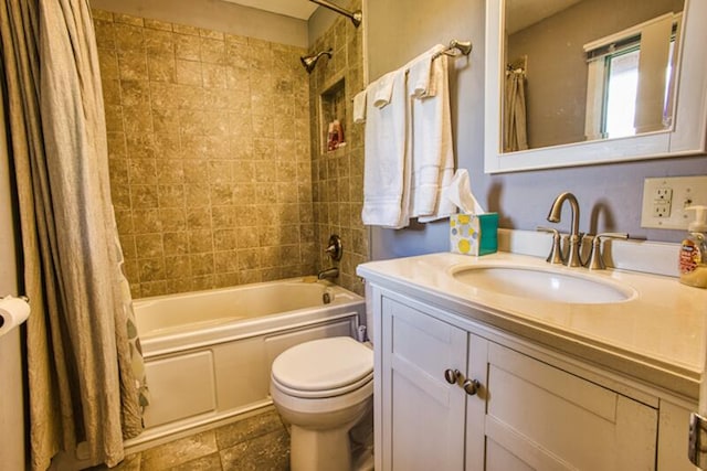 full bathroom with tile flooring, vanity with extensive cabinet space, toilet, and shower / tub combo