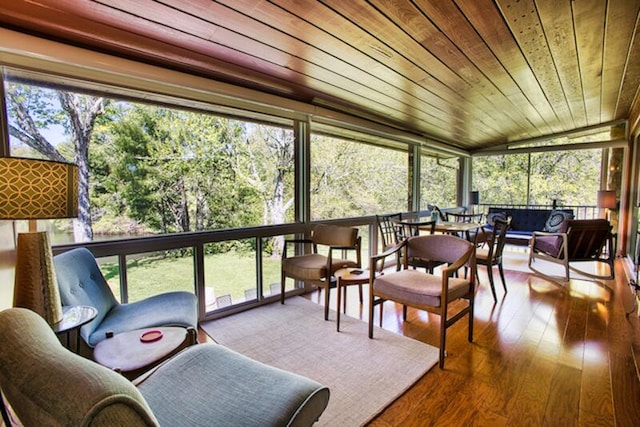 sunroom / solarium featuring lofted ceiling and wood ceiling