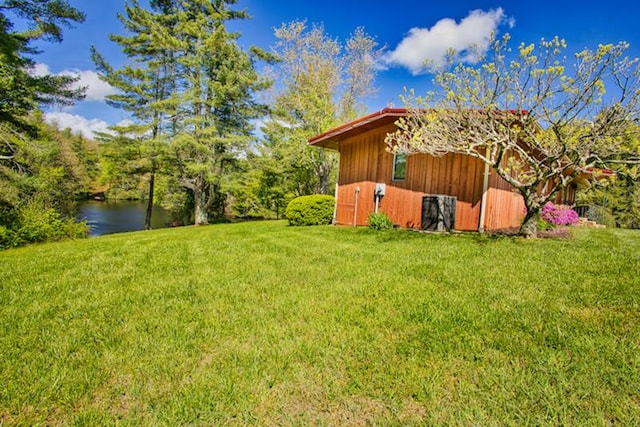 view of yard with an outdoor structure and a water view