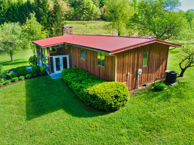 back of property featuring a yard, central air condition unit, and french doors