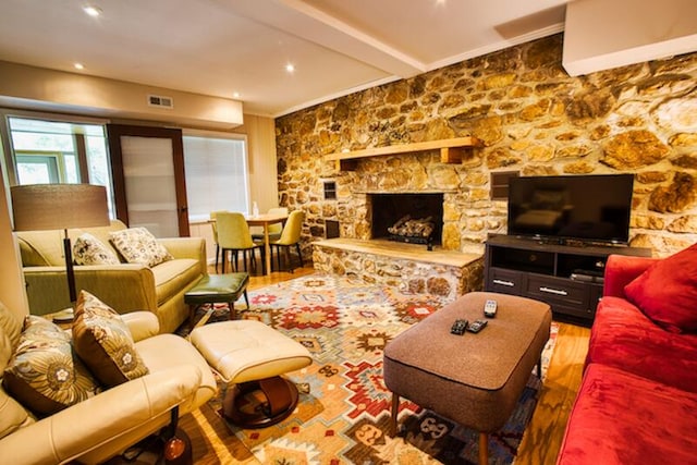 living room with hardwood / wood-style floors and a fireplace