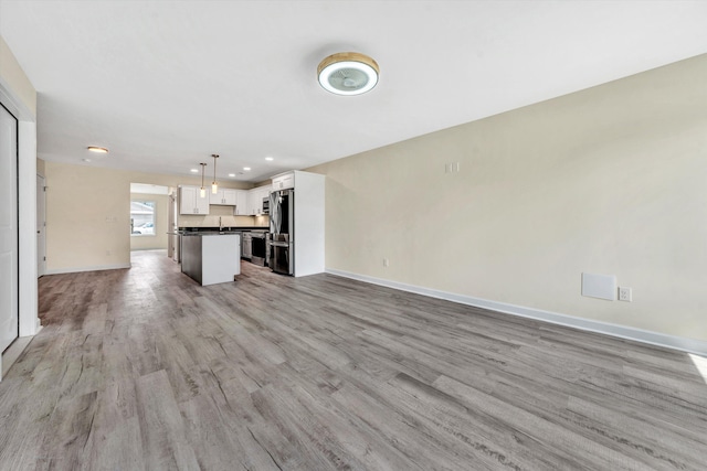 unfurnished living room with light wood-type flooring